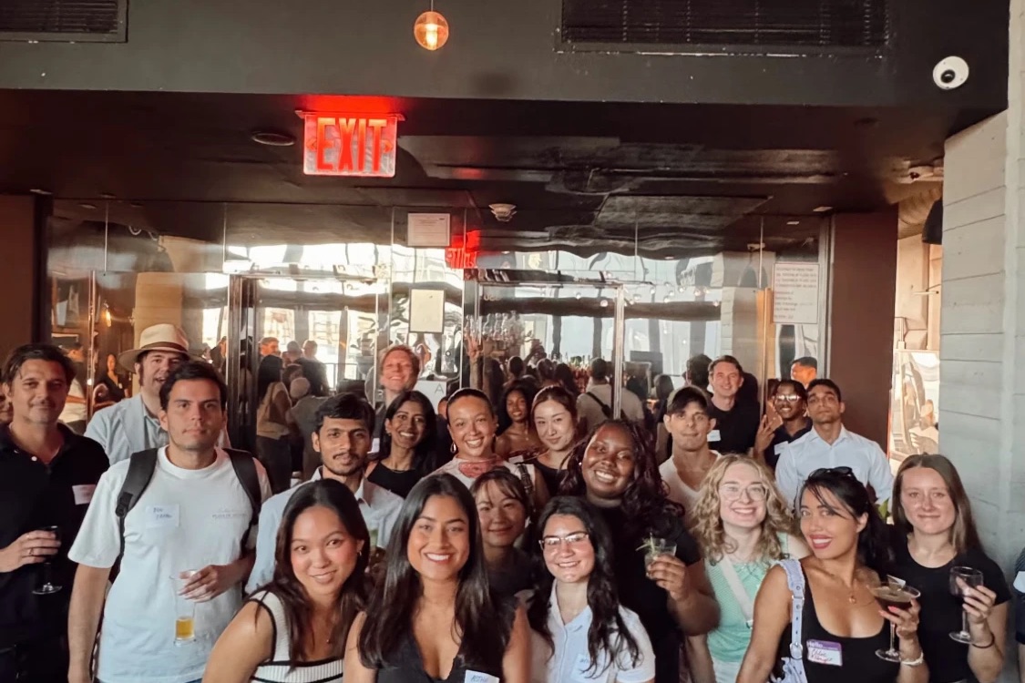 A big group photo of Design Lounge members gathered behind the bar